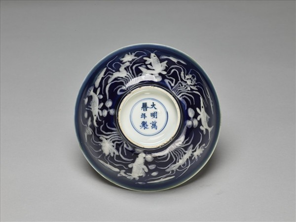 藍地堆白蓮塘游魚紋碗